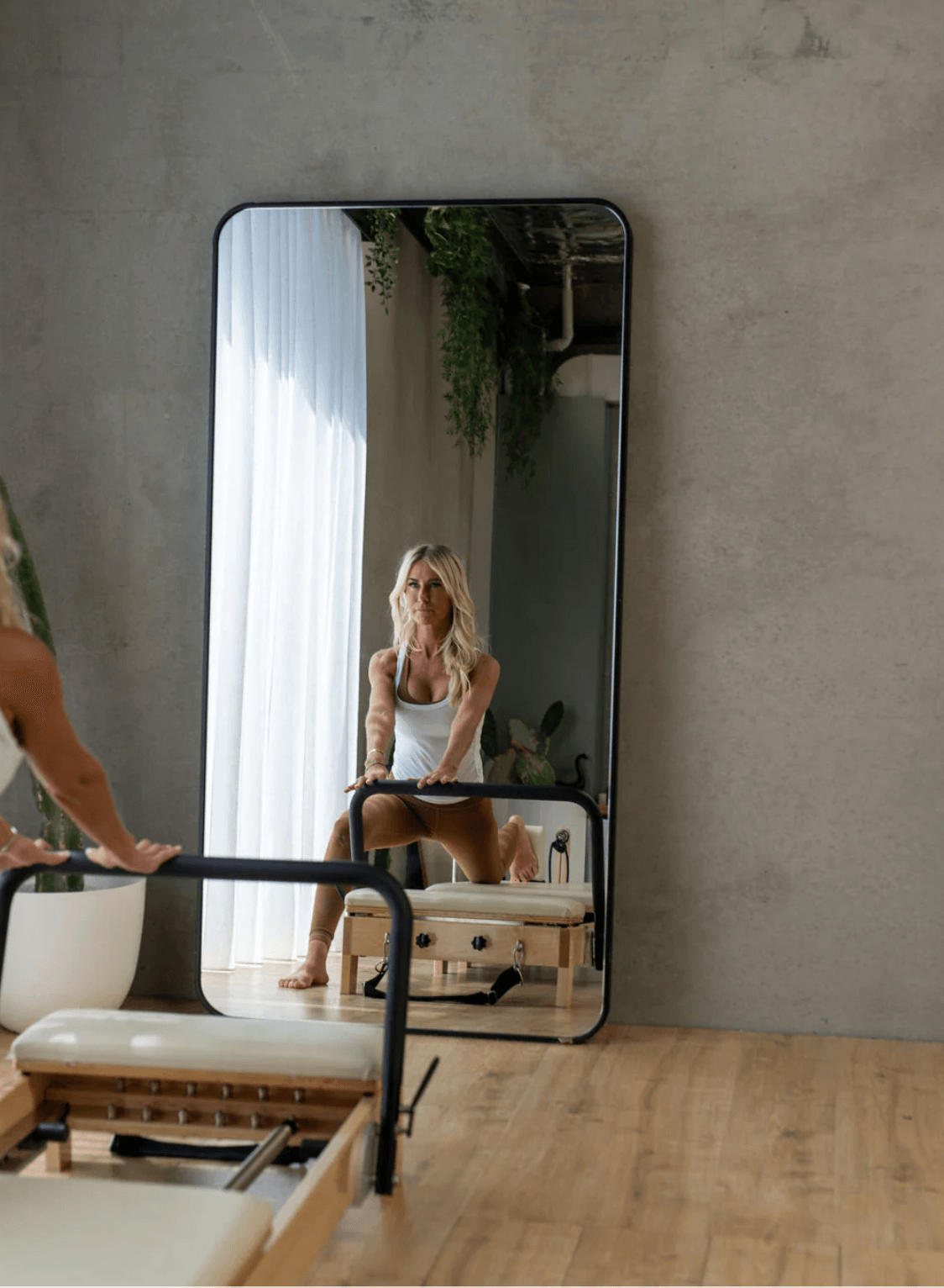 Affordable Pilates reformer folded upright in small home space